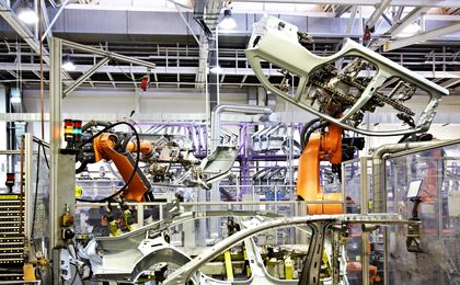 robotic arms in a car factory